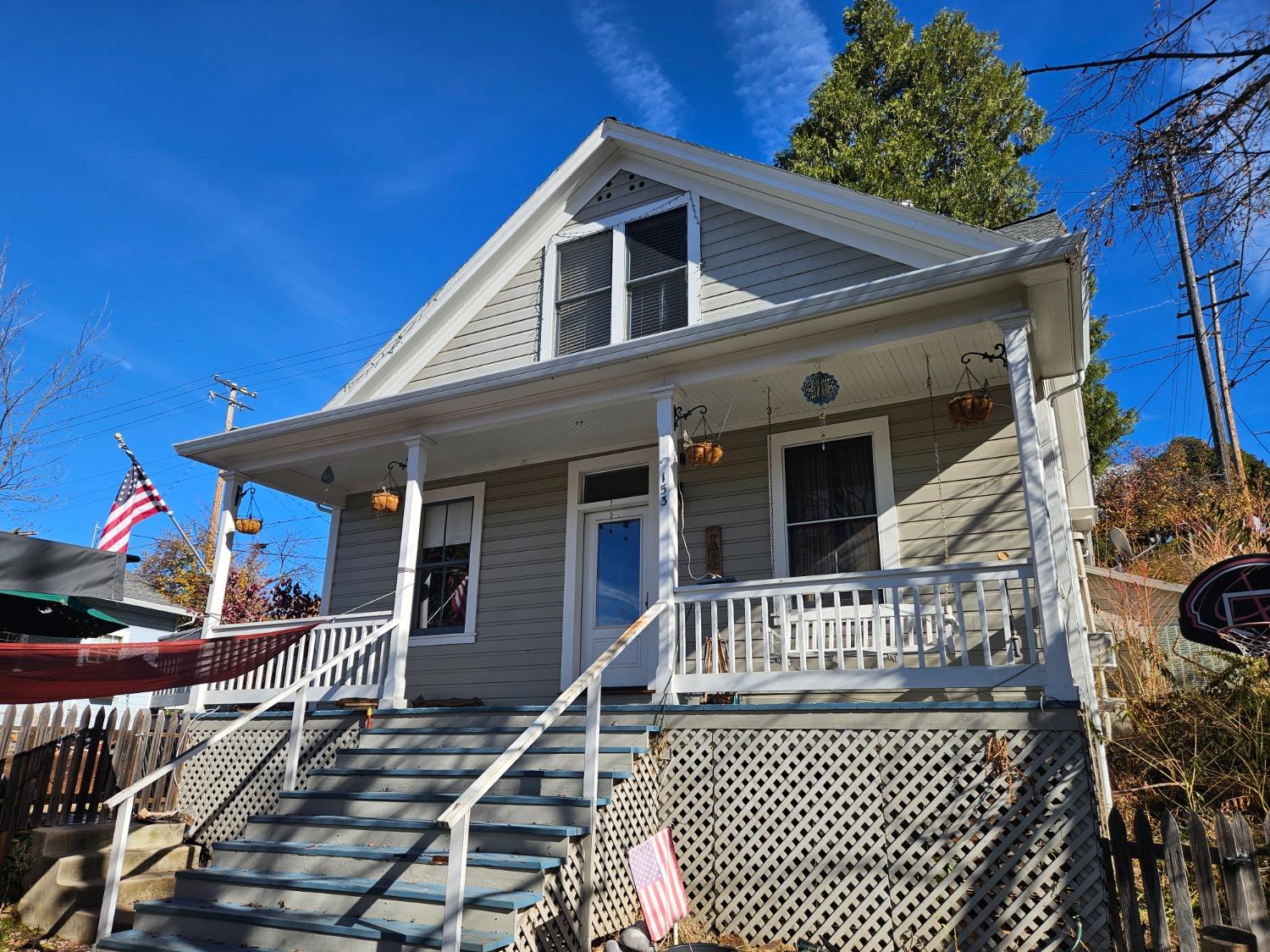 a view of a house with wooden deck and furniture