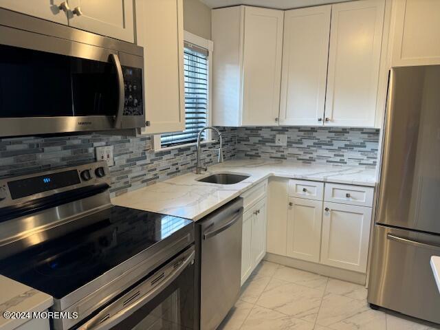 a kitchen with a sink stove and microwave