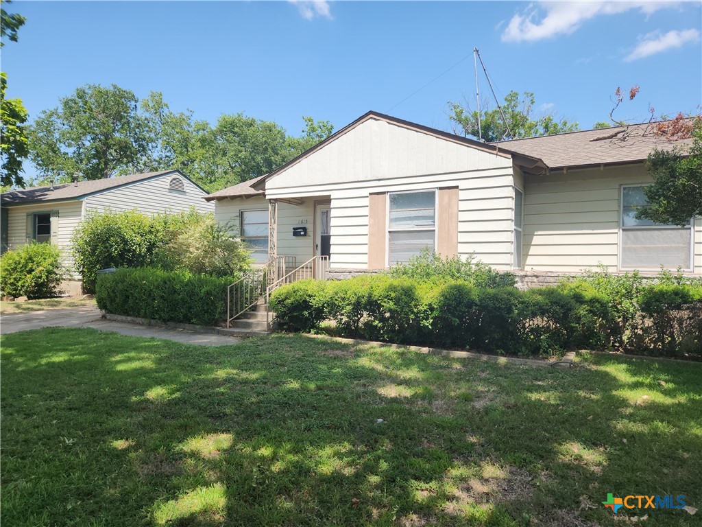 a front view of a house with a yard