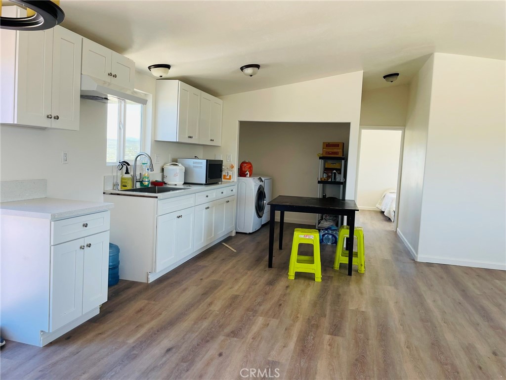 a living room with kitchen island furniture and a wooden floor