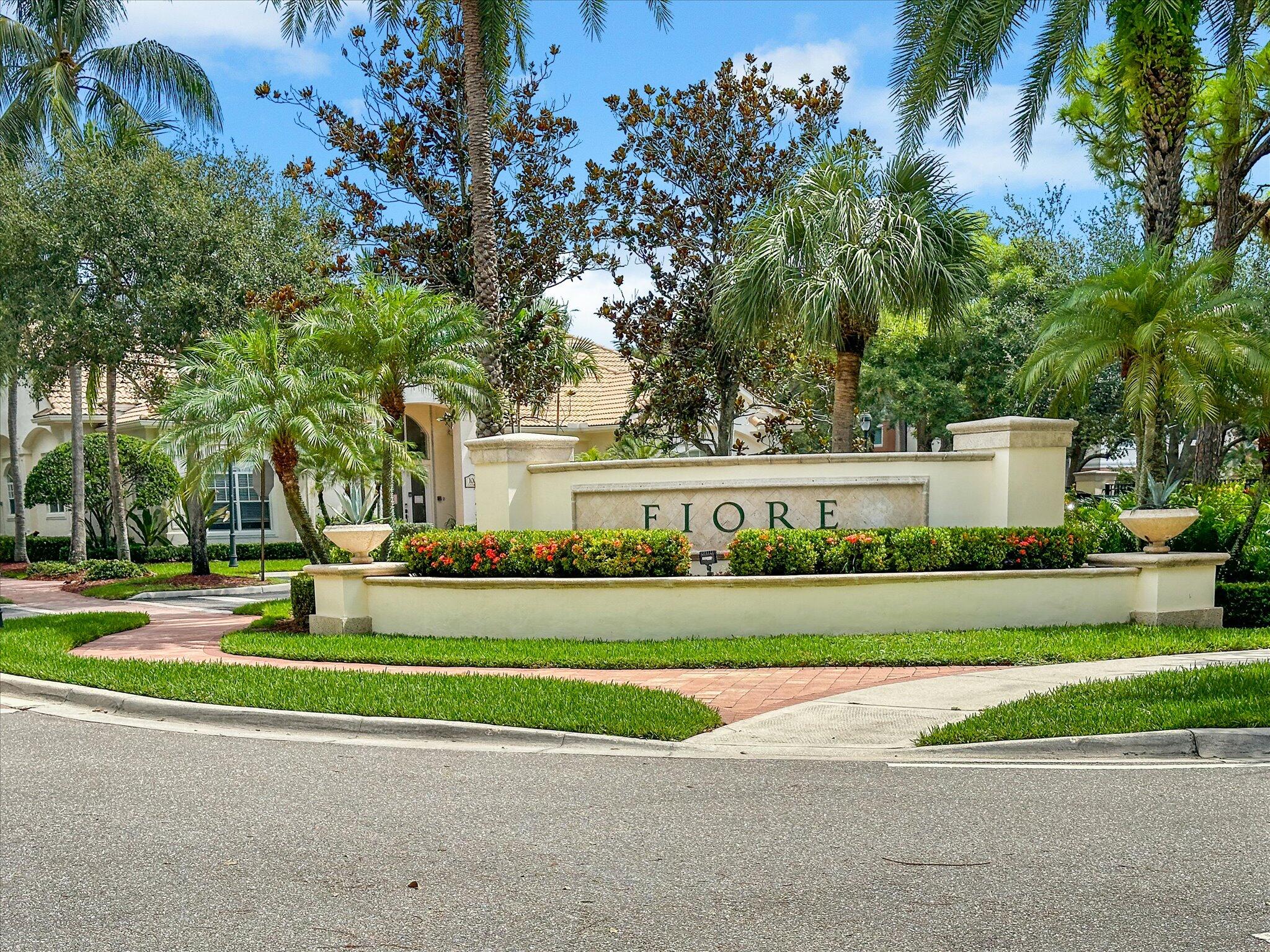 a view of a house in a big yard with plants and large trees