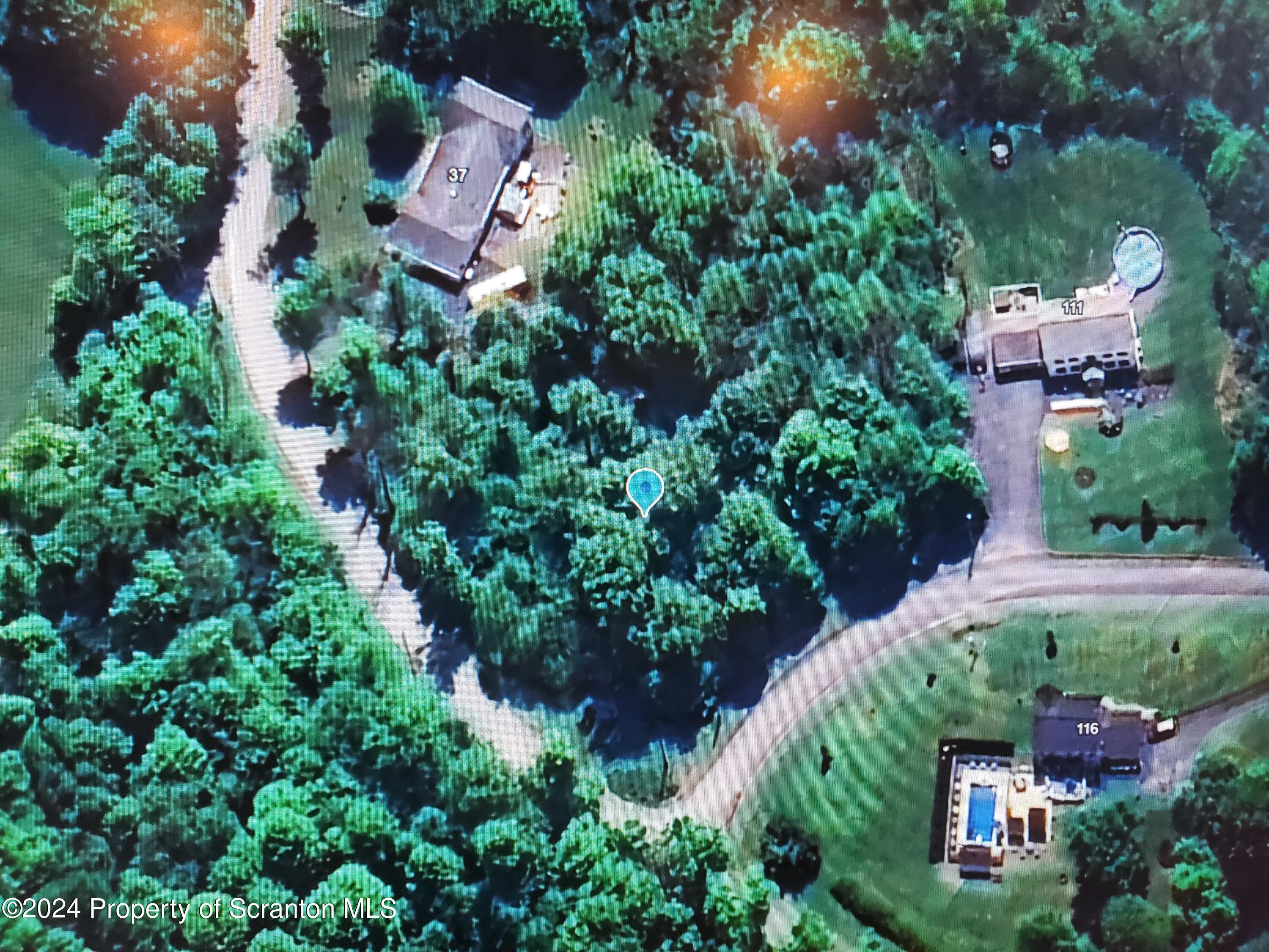 an aerial view of a house with a yard and garden