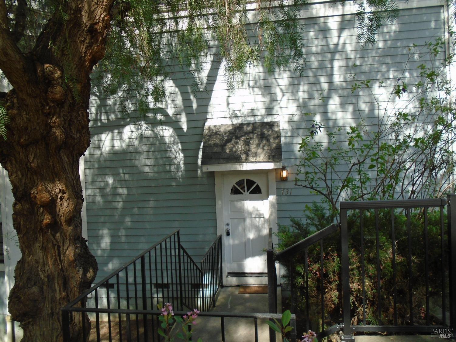 a view of house with a tree in front