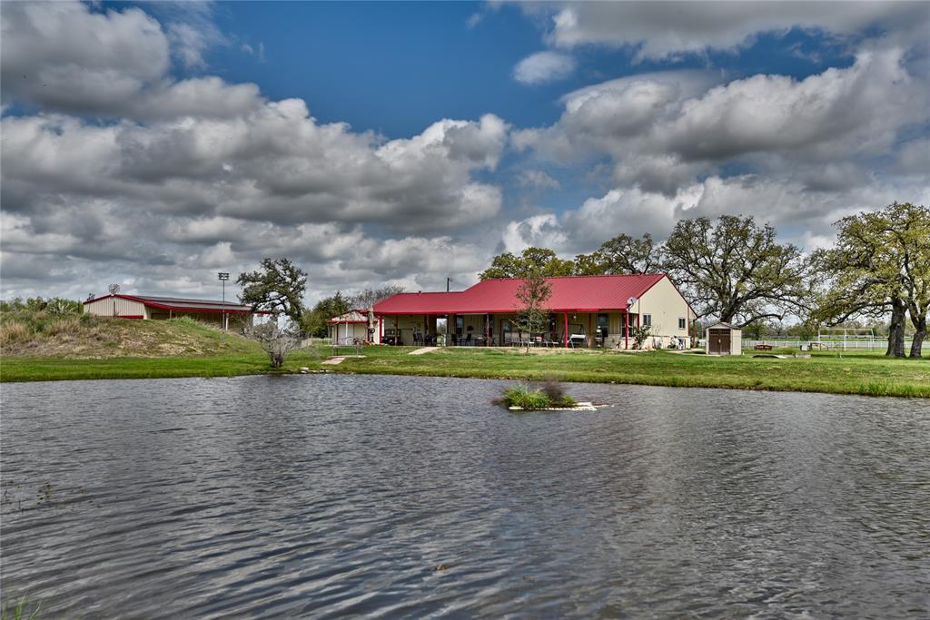 View of fishing pond and back of main house, south barndo to the left. Zipline off to the right.