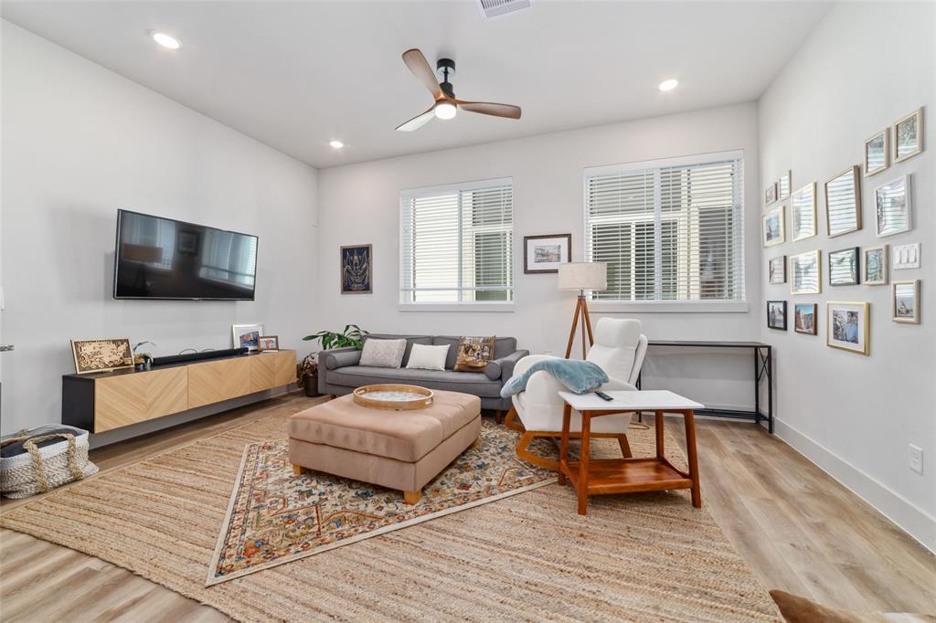 a living room with furniture wooden floor and a flat screen tv