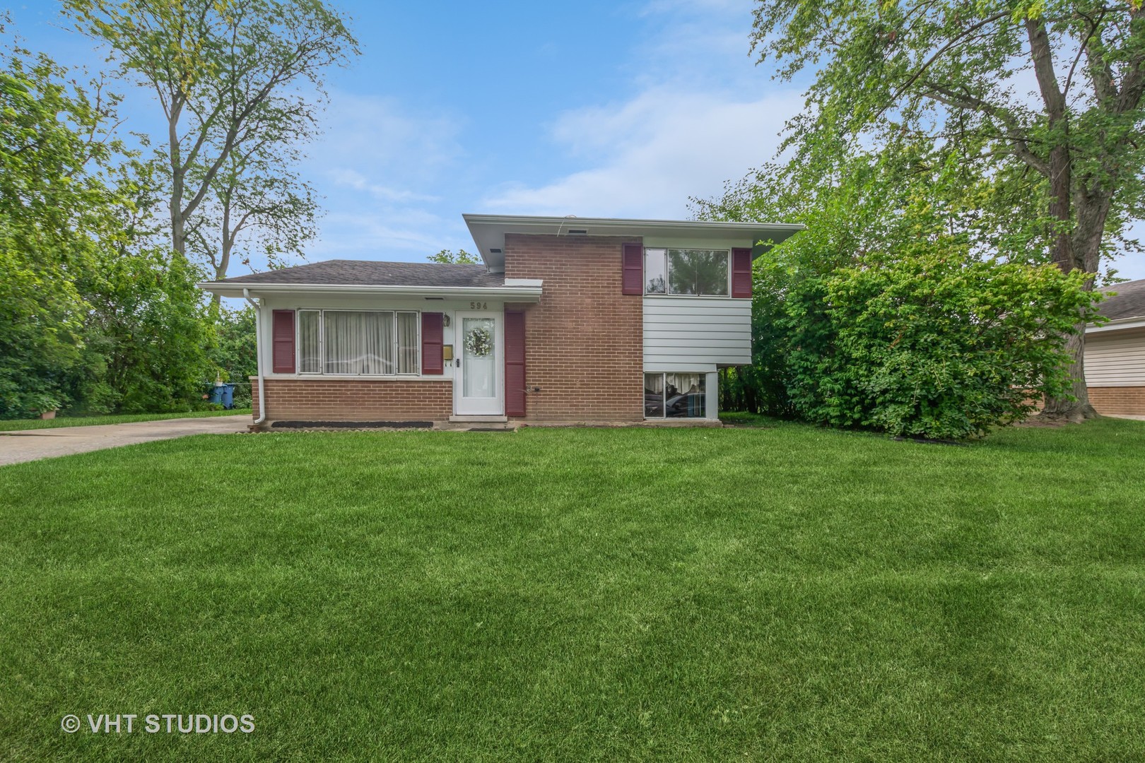 a front view of house with yard and green space