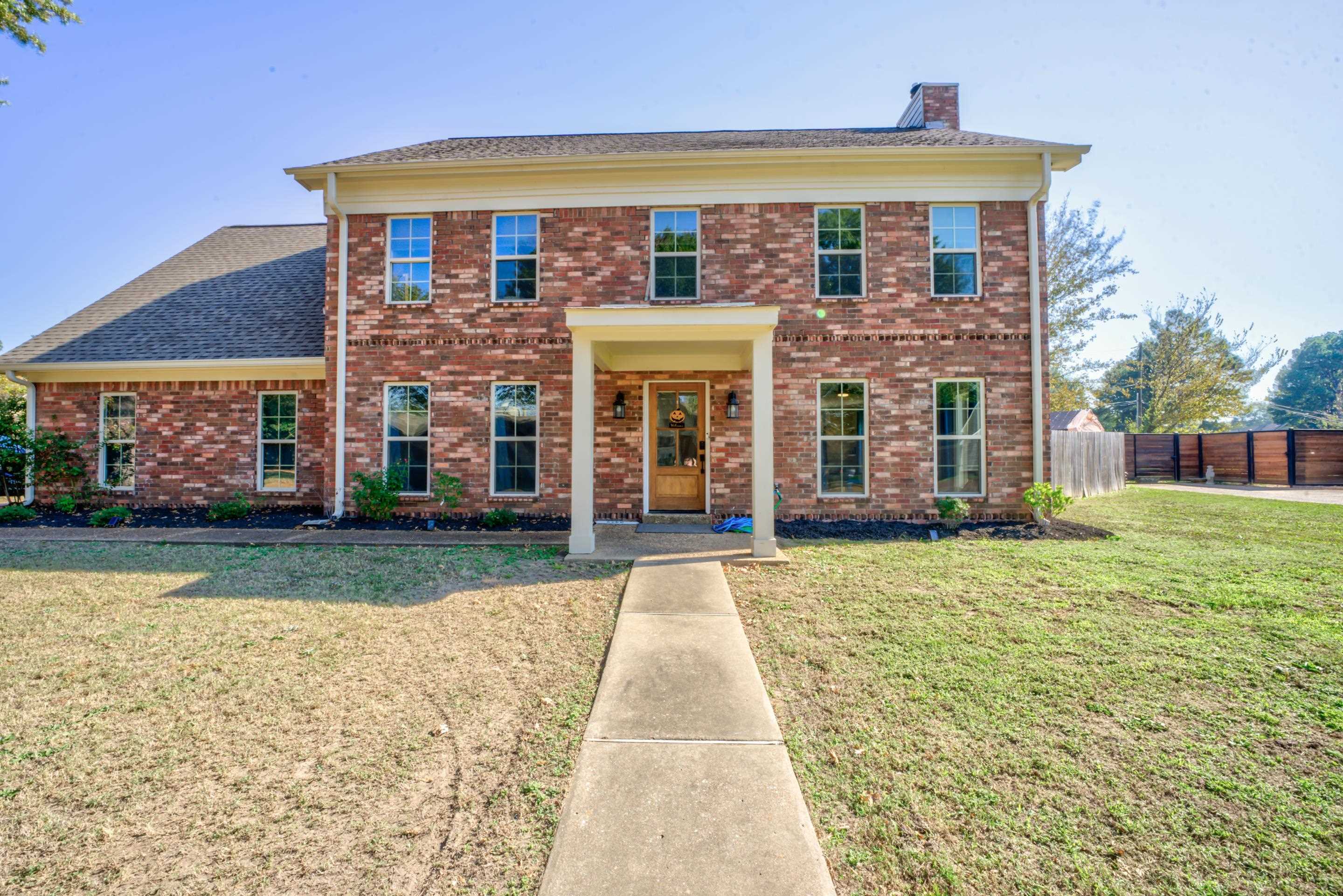 Colonial-style house with a front lawn