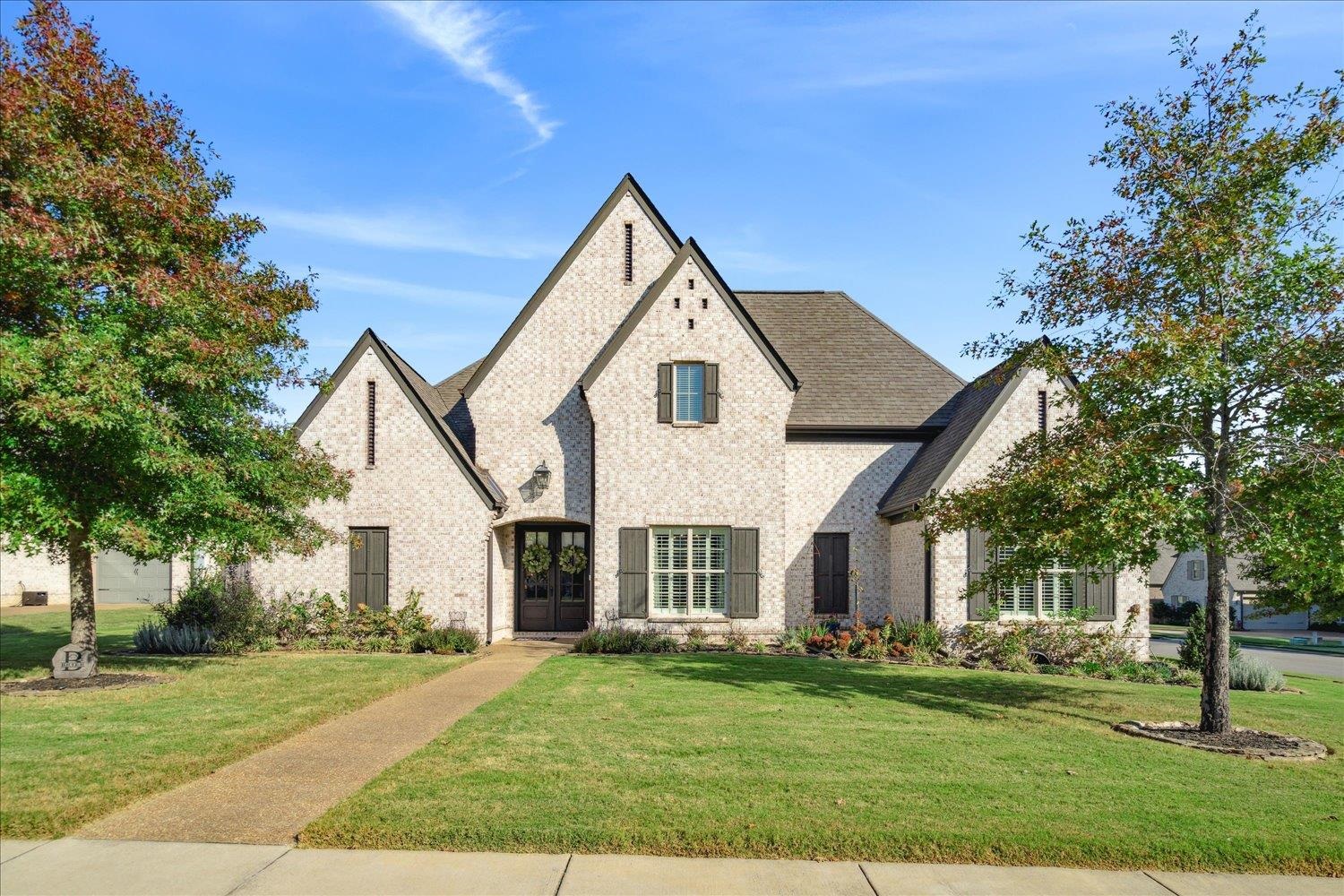 a front view of a house with a yard