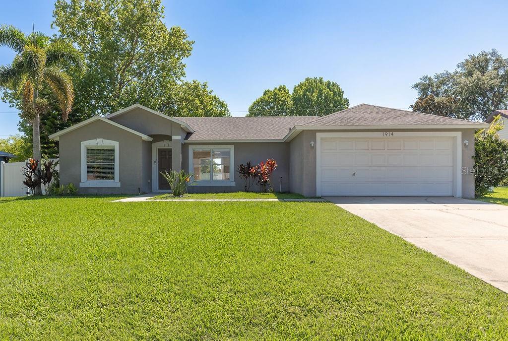 a front view of house with yard and green space