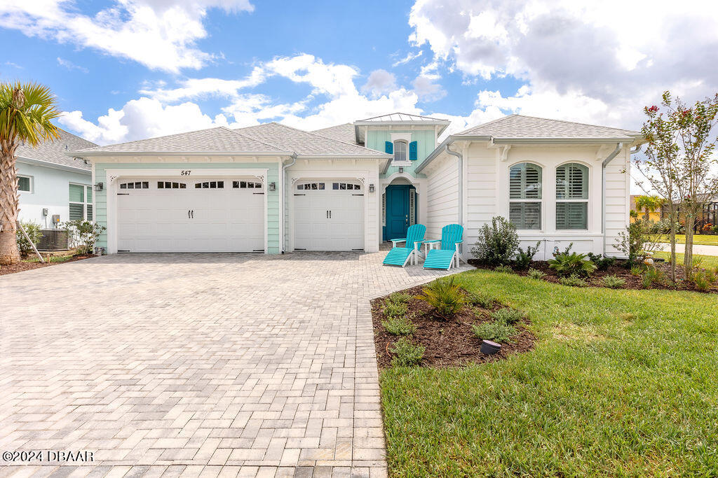 a front view of a house with a yard and garage