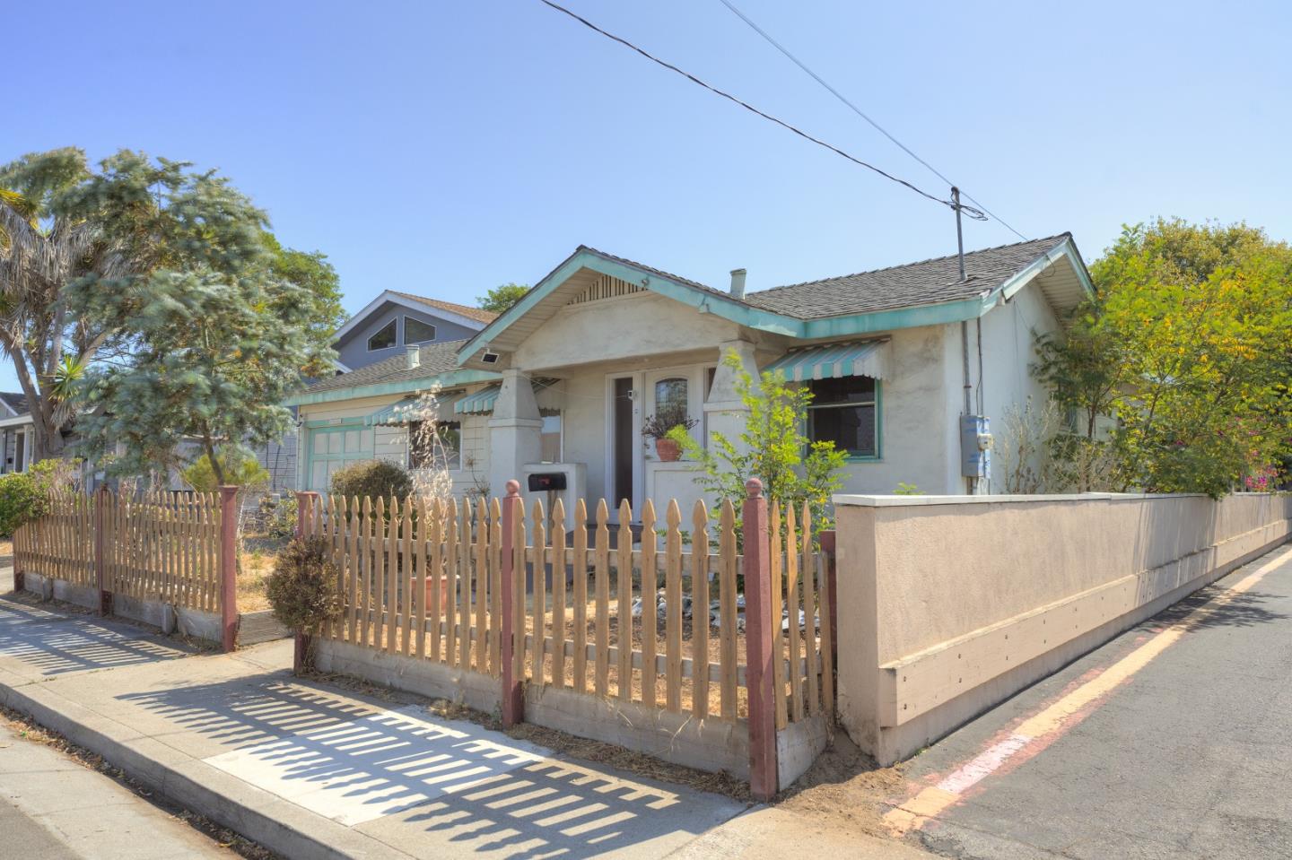 a front view of a house with wooden fence