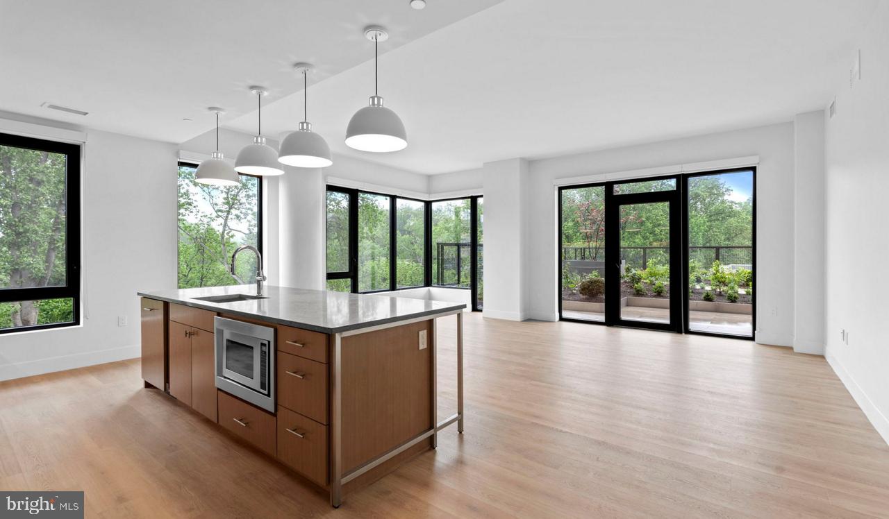 a view of kitchen with stove and wooden floor