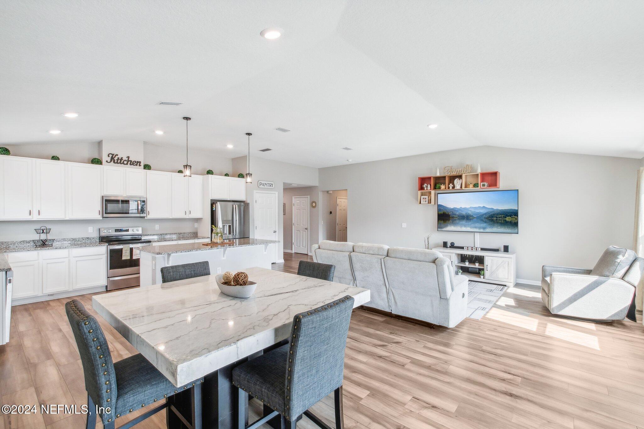 a kitchen with a table and chairs in it