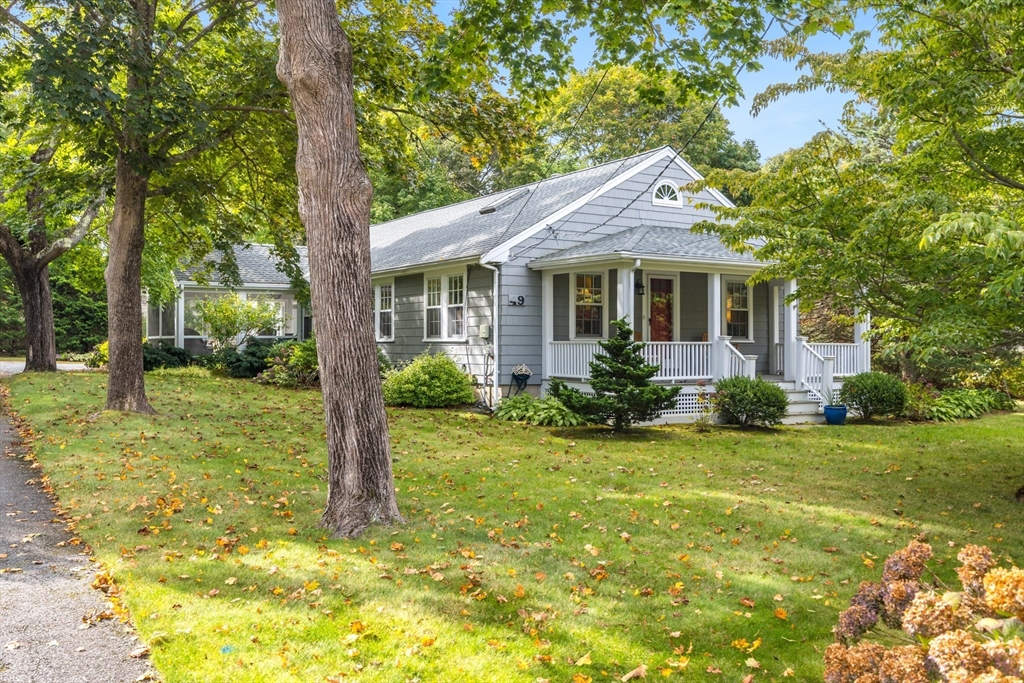 a view of a house with backyard and a tree