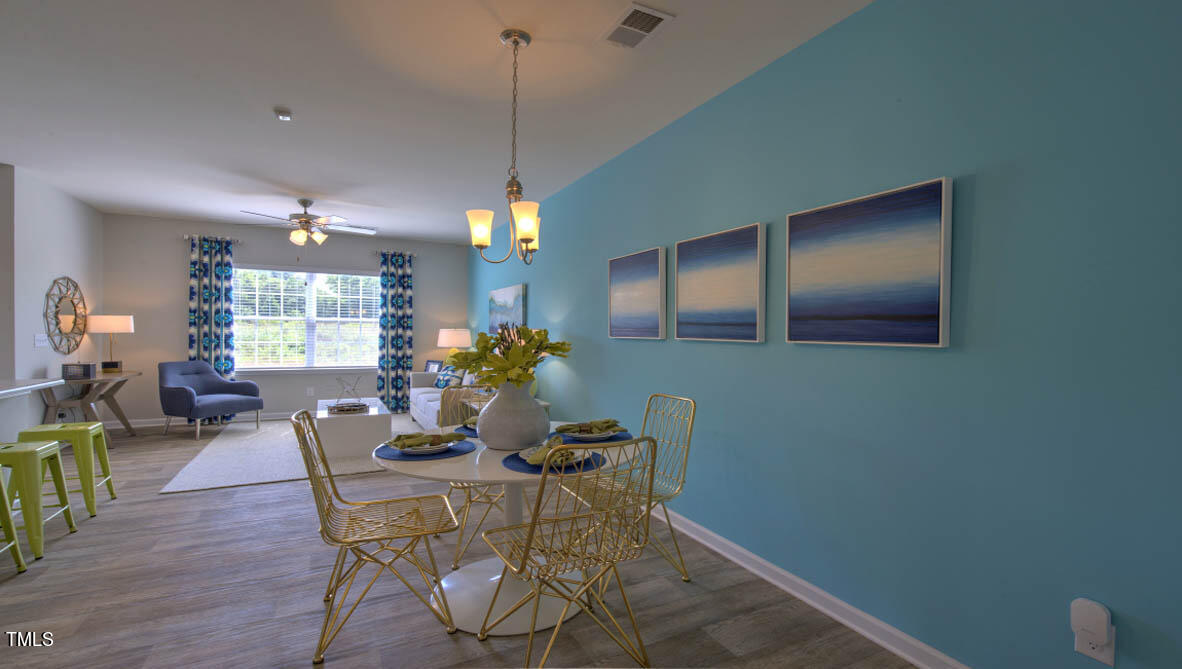 a view of a dining room with furniture and a chandelier