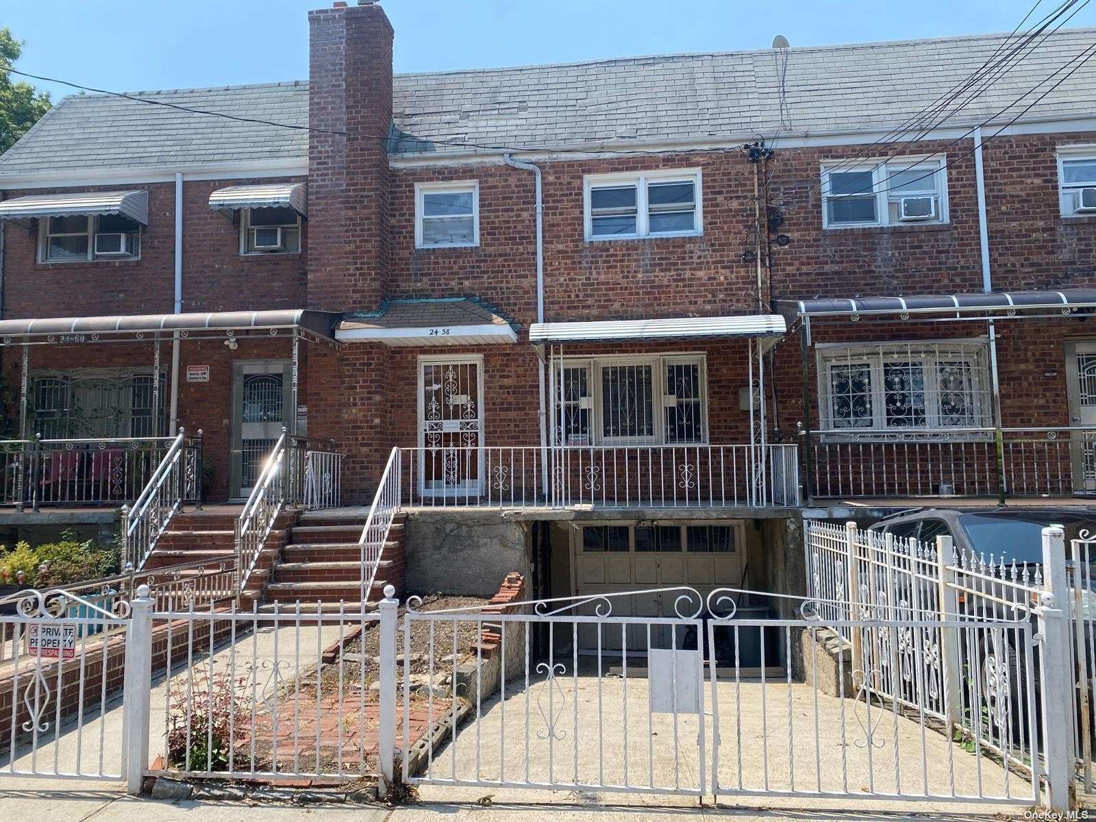 a view of a brick house with large windows and a table