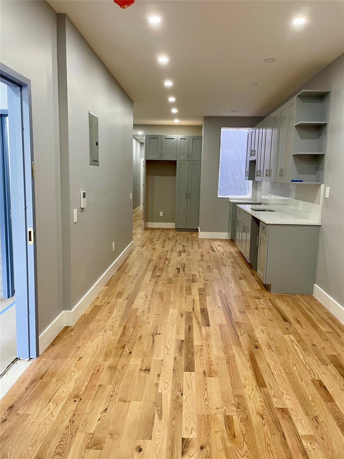 Kitchen featuring gray cabinets and light hardwood / wood-style flooring