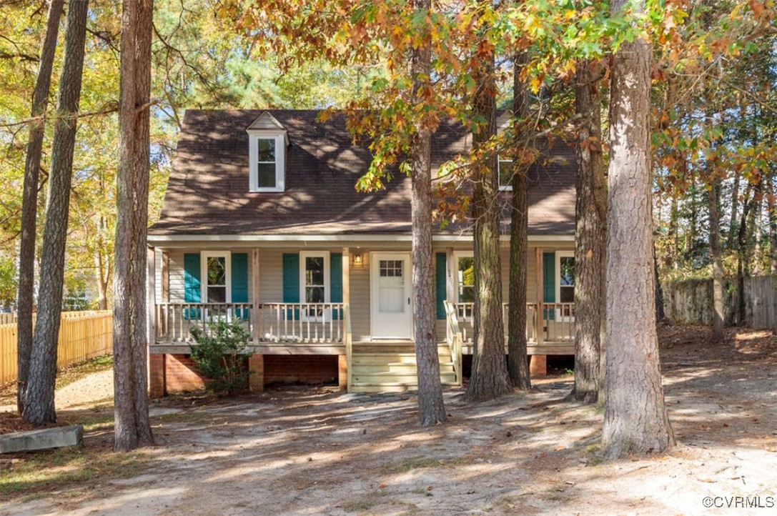 a view of a house with a tree in front