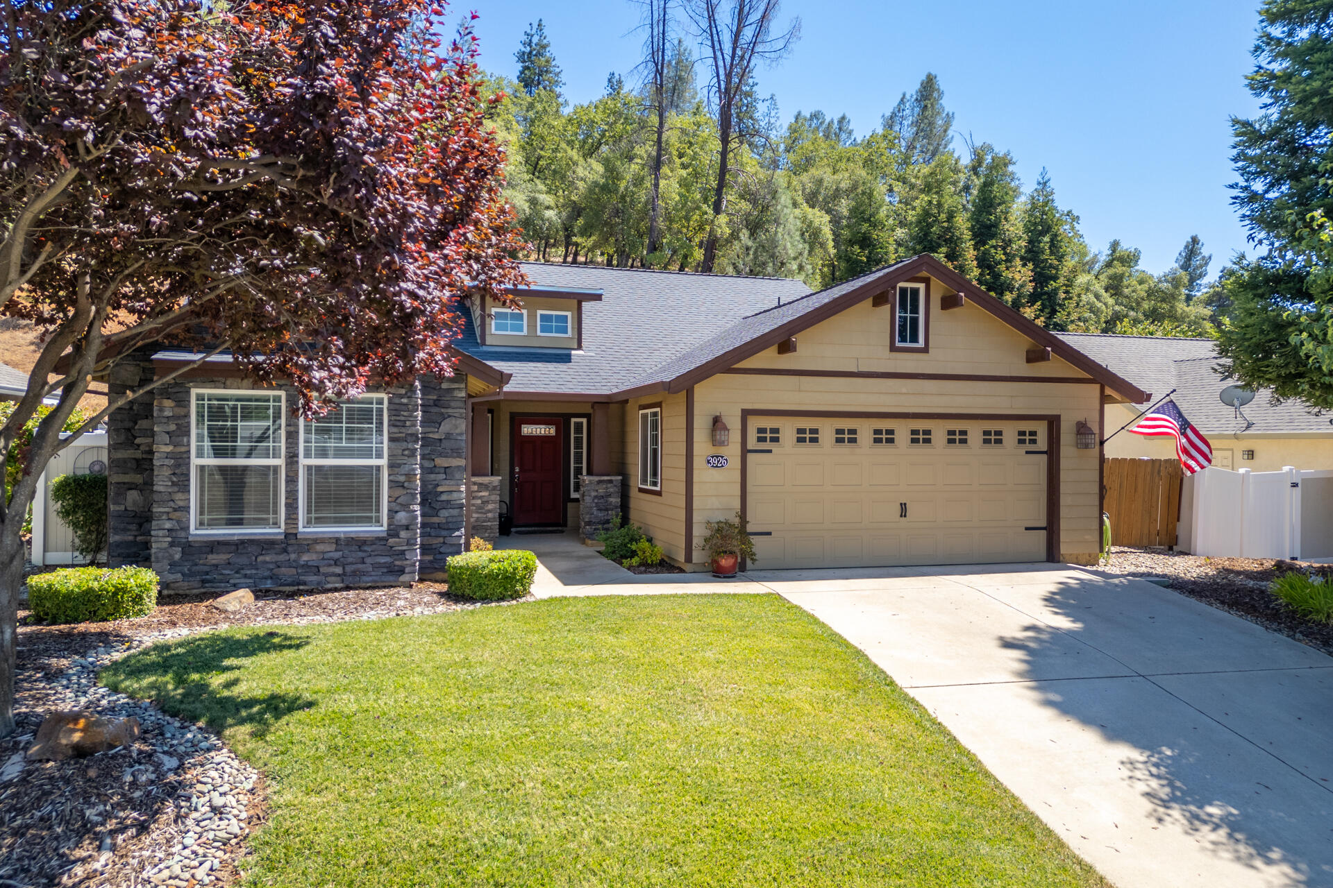 a front view of a house with a yard and trees