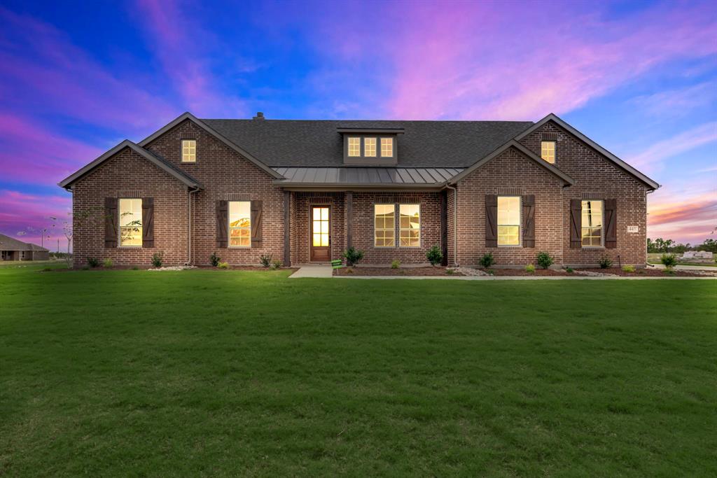 a front view of a house with a garden