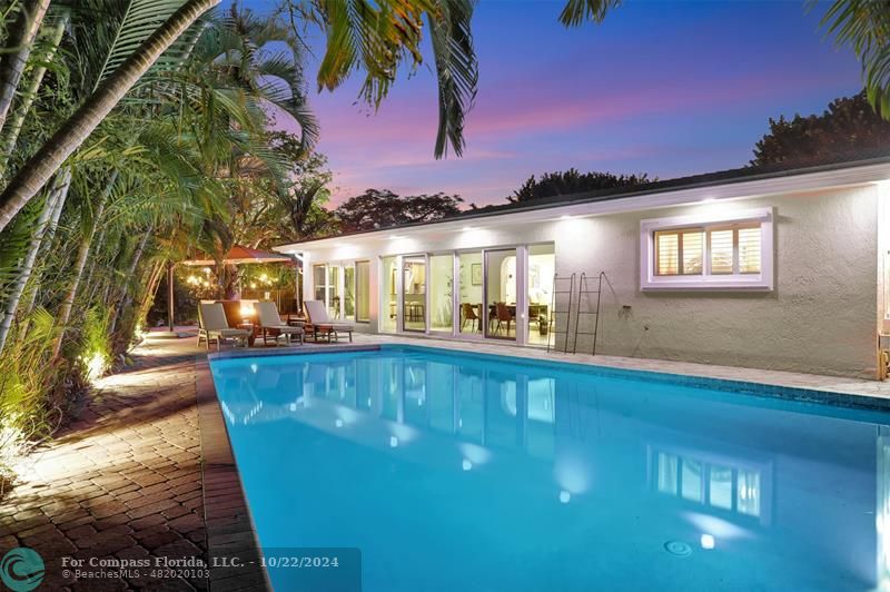 a view of a swimming pool with an outdoor seating