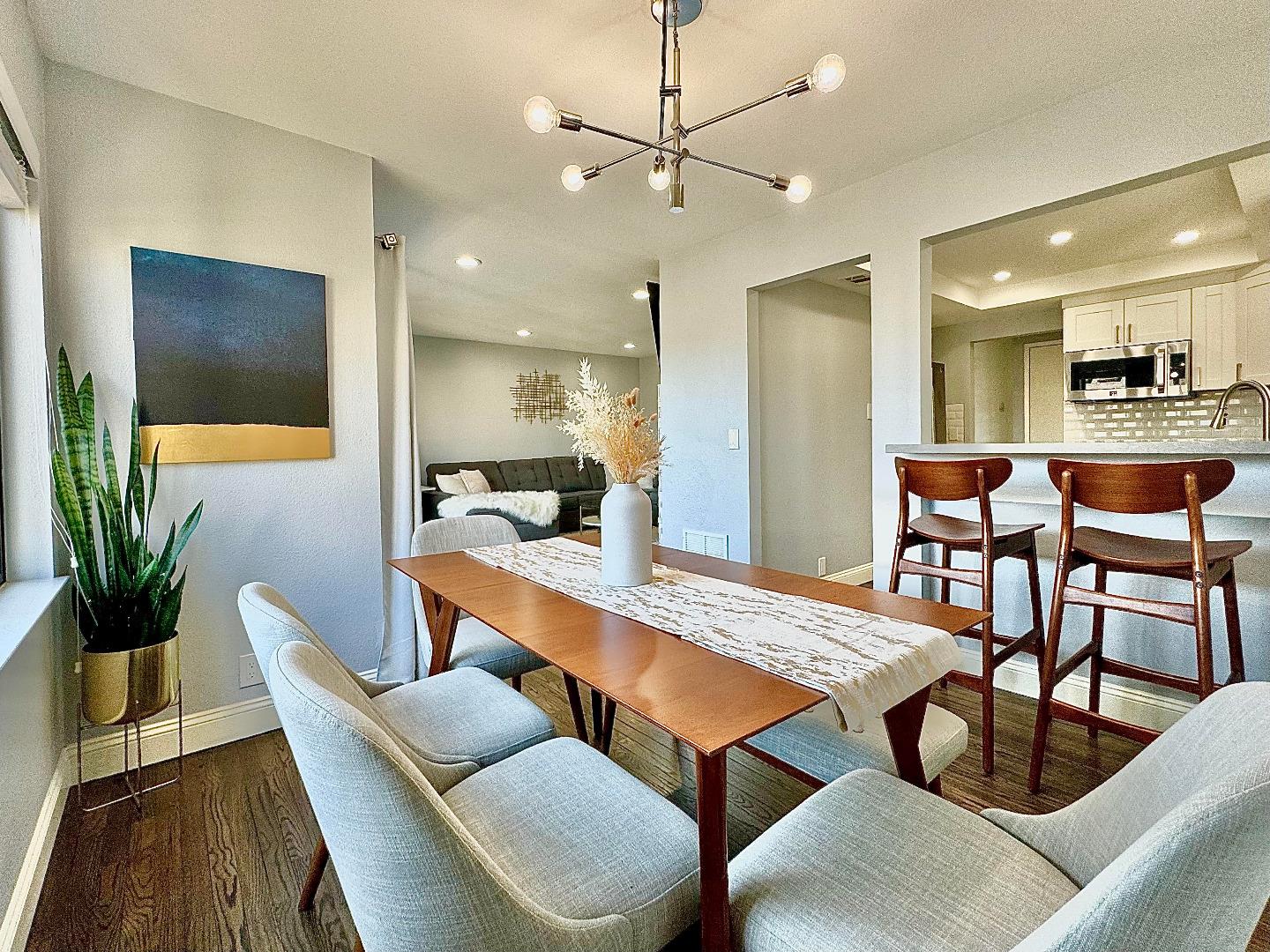 a dining room with furniture and wooden floor