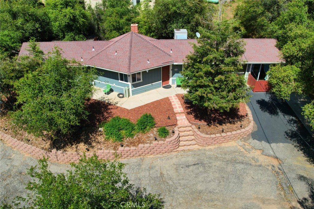 a view of house with garden space and trees