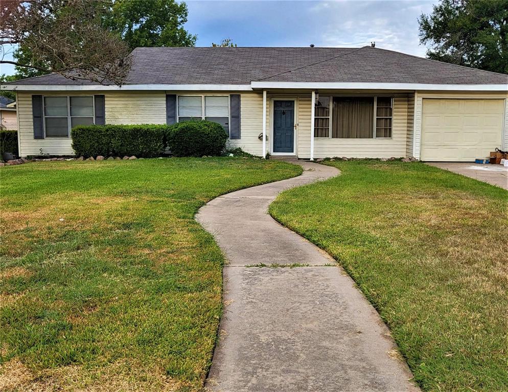 a front view of a house with yard and green space