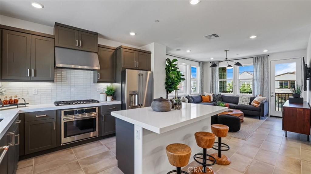 a kitchen with sink a stove and cabinets