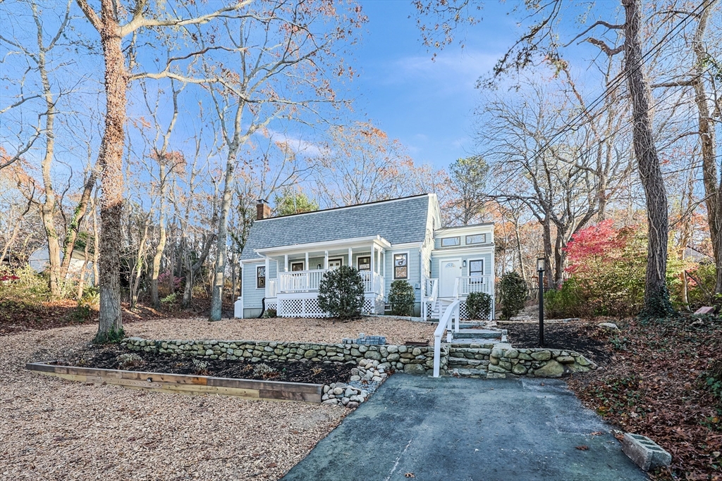 a view of a house with a yard covered with snow