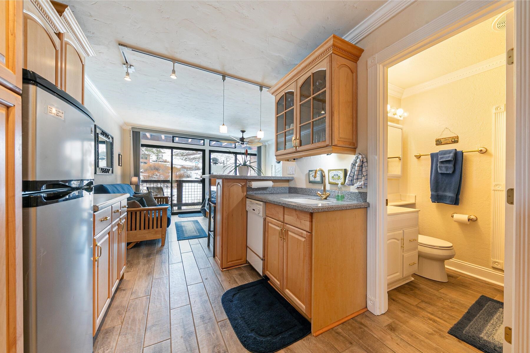 a living room with stainless steel appliances furniture and a large window