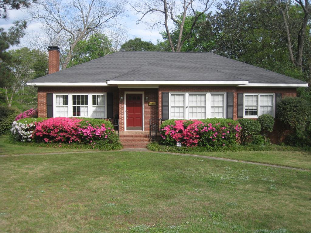 a front view of a house with garden