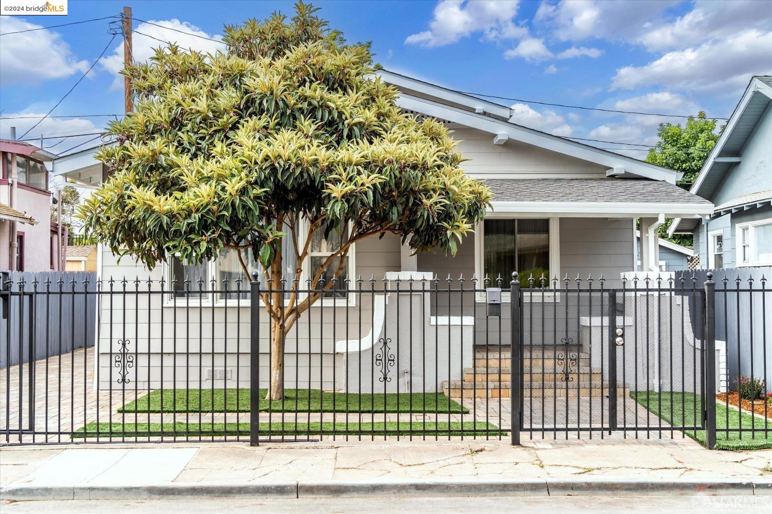 a view of a house with a small yard and plants