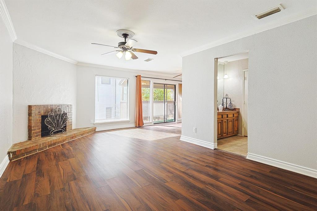 a view of a livingroom with wooden floor and a ceiling fan