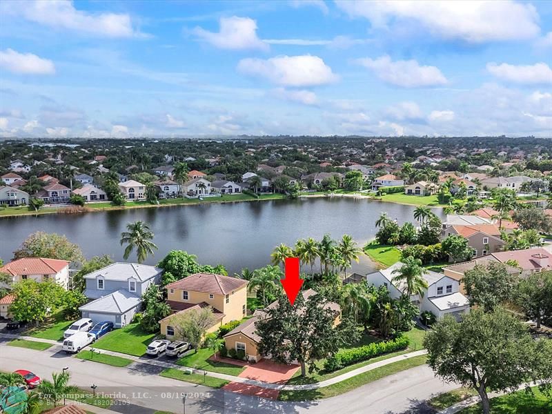 an aerial view of a house with a lake view