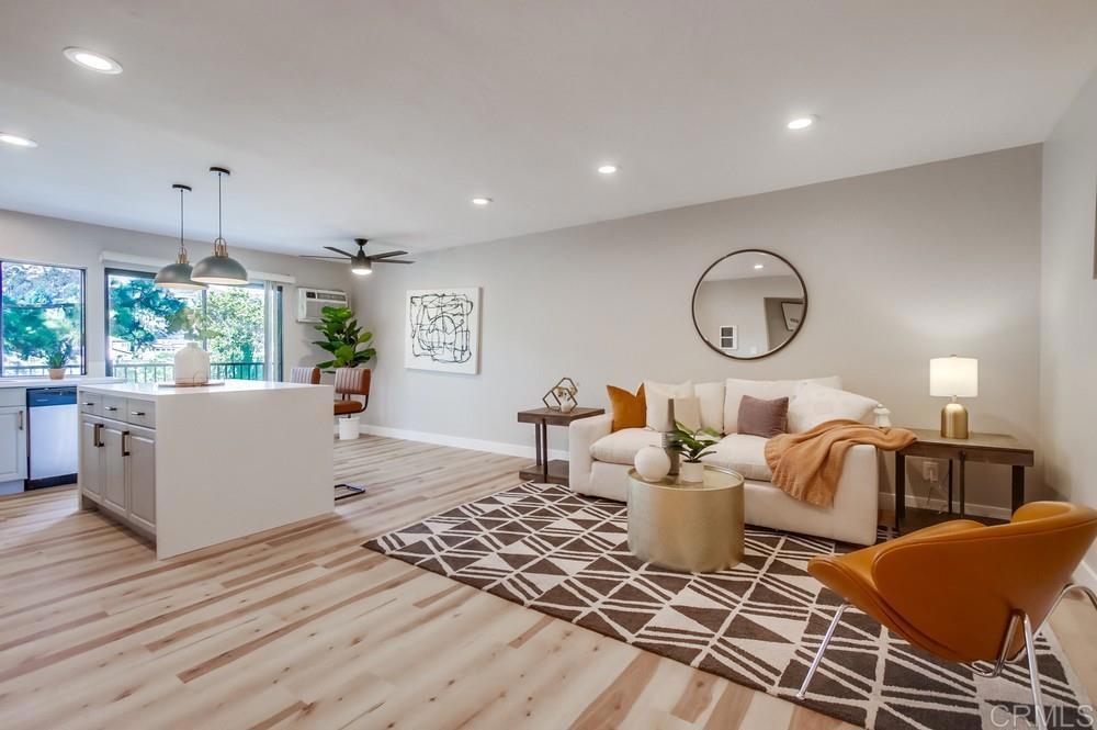 a living room with lots of furniture and painting on the wall