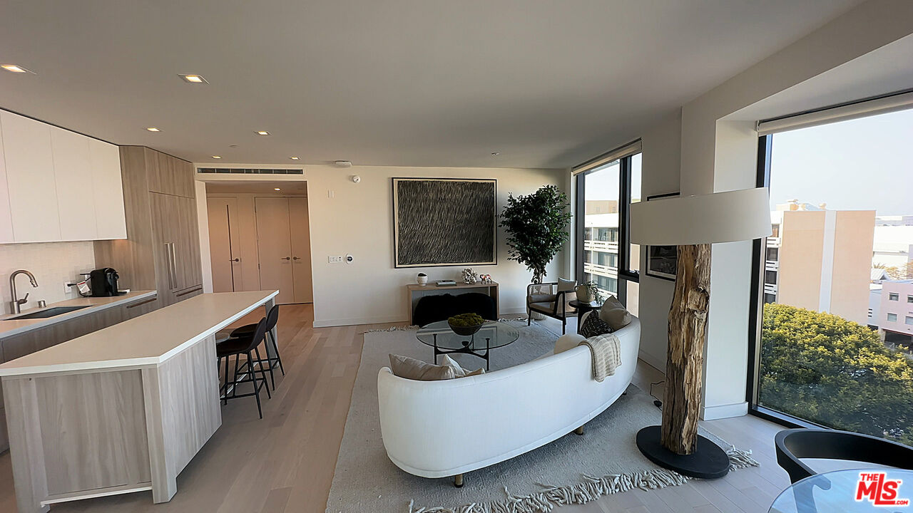 a living room with furniture a large window and a fireplace