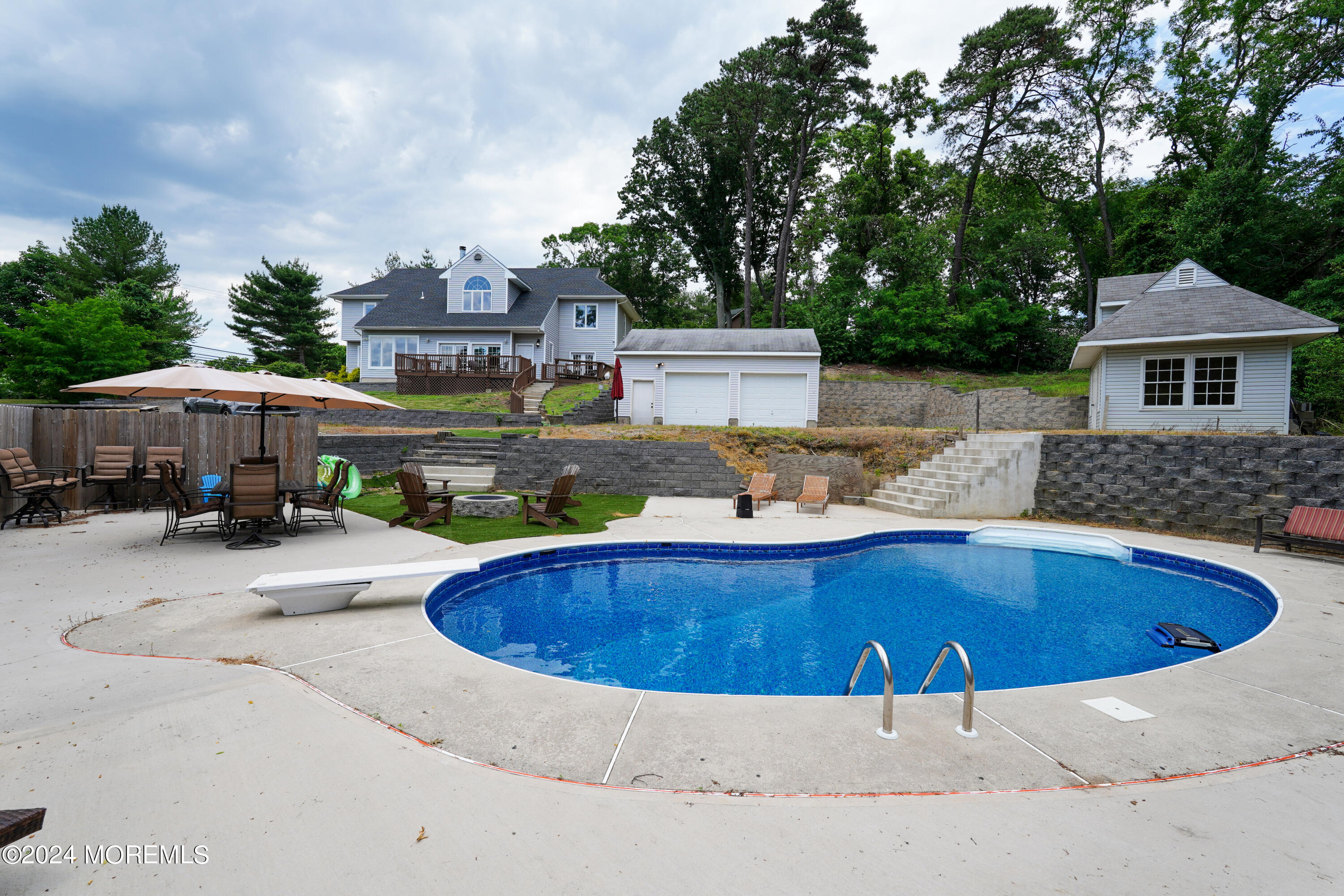 a view of swimming pool with outdoor seating and plants