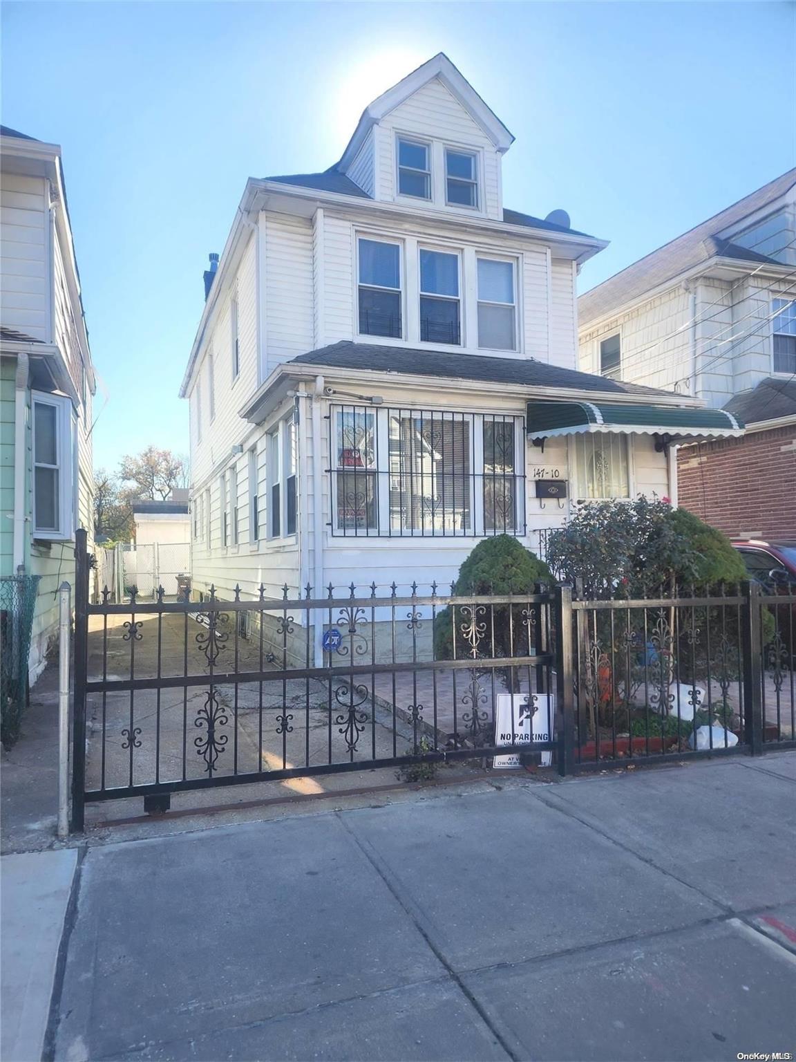 a front view of a house with iron fence