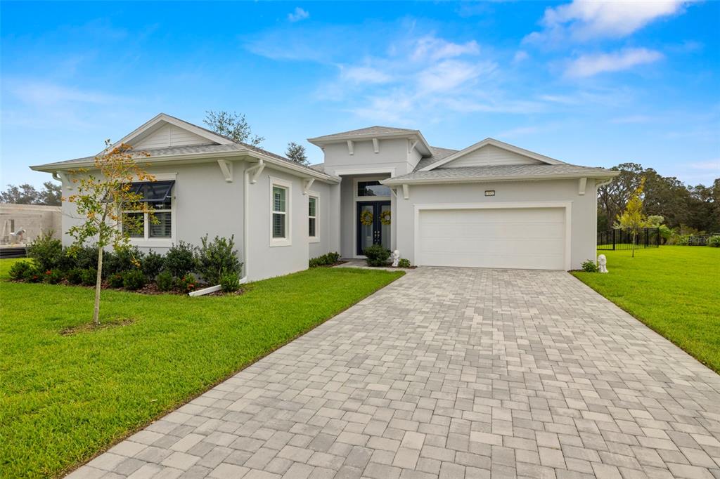 a front view of a house with a yard and garage