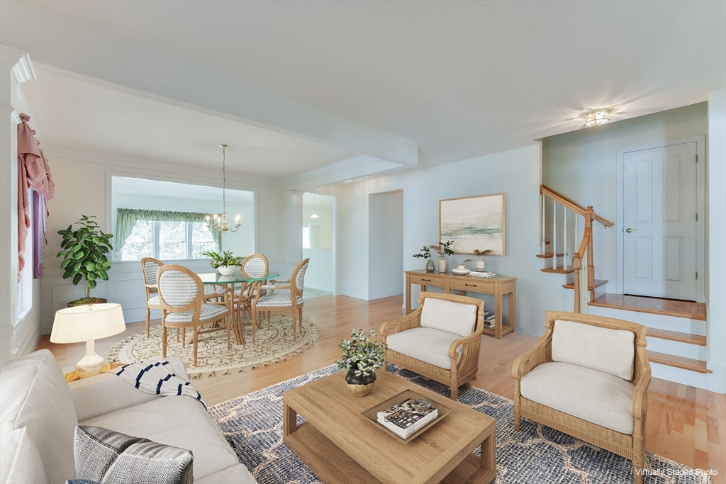 a living room with furniture a rug and a table