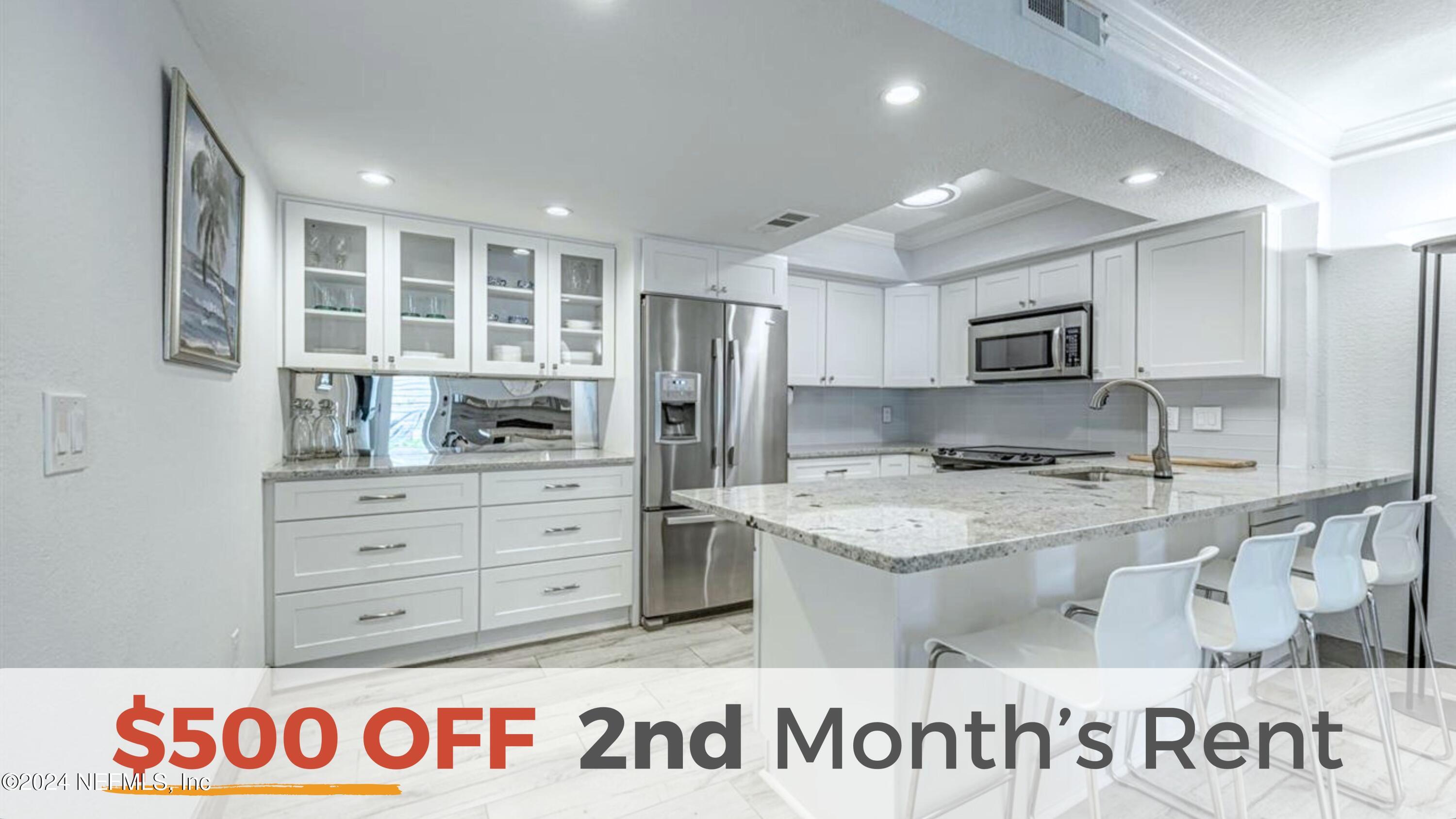 a kitchen with granite countertop a sink and a stove