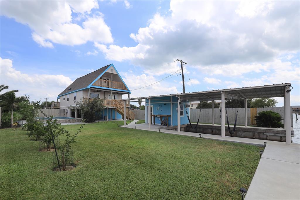 a view of a house with a yard and sitting area