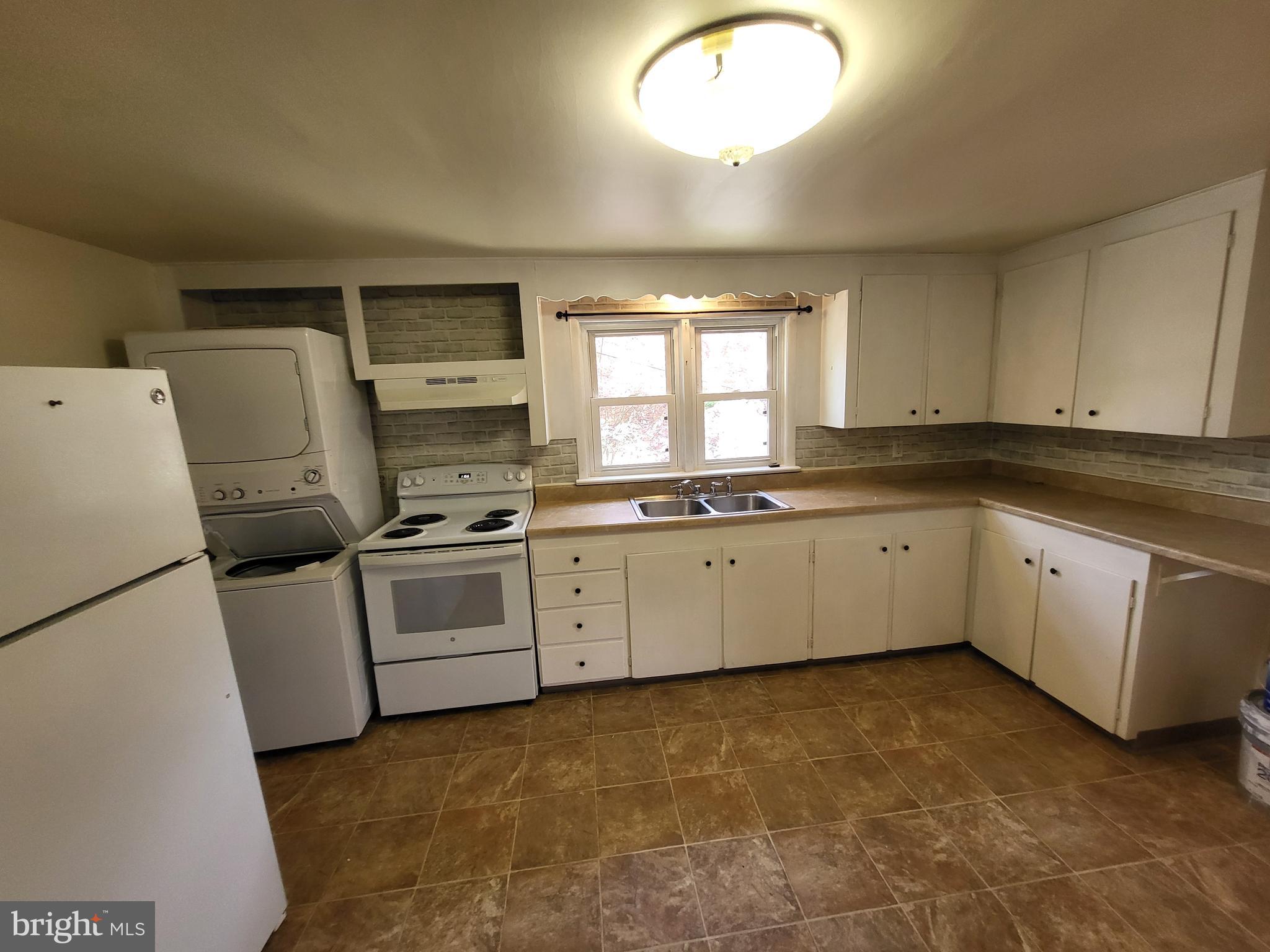 a kitchen with a white cabinets and white appliances