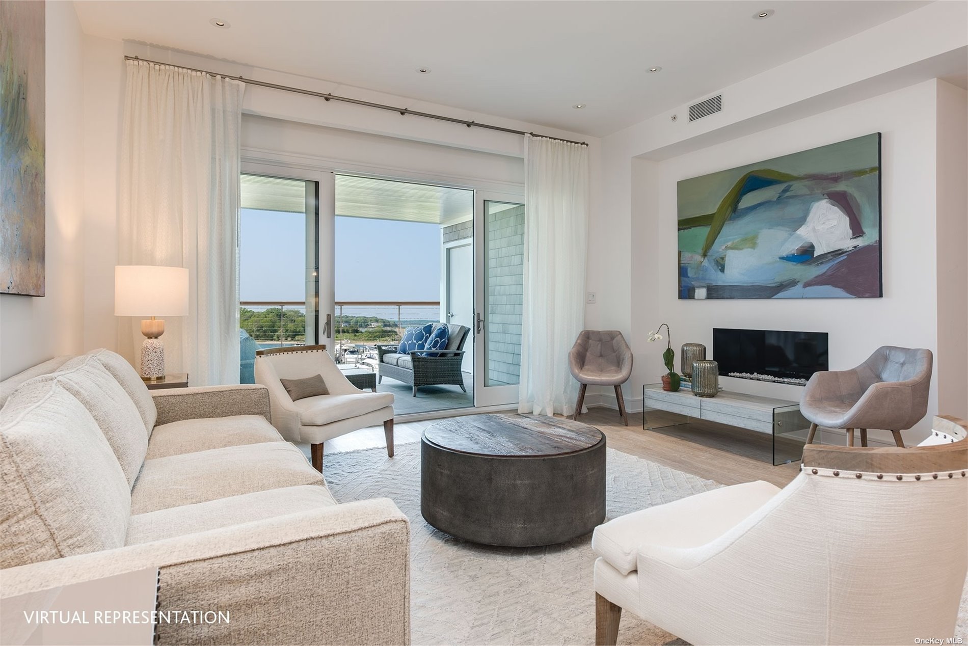 a living room with furniture a large window and a fireplace