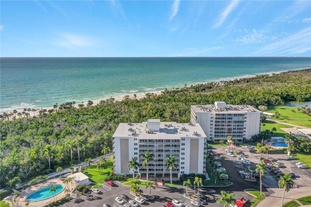 Drone / aerial view featuring a beach view and a water view