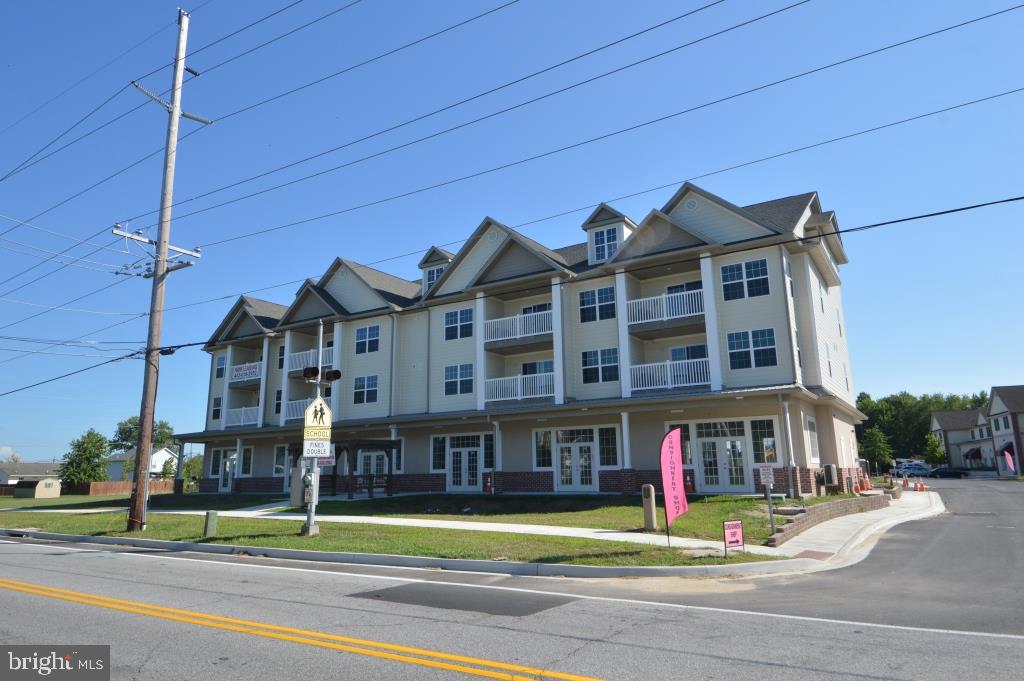 a front view of a building with a yard