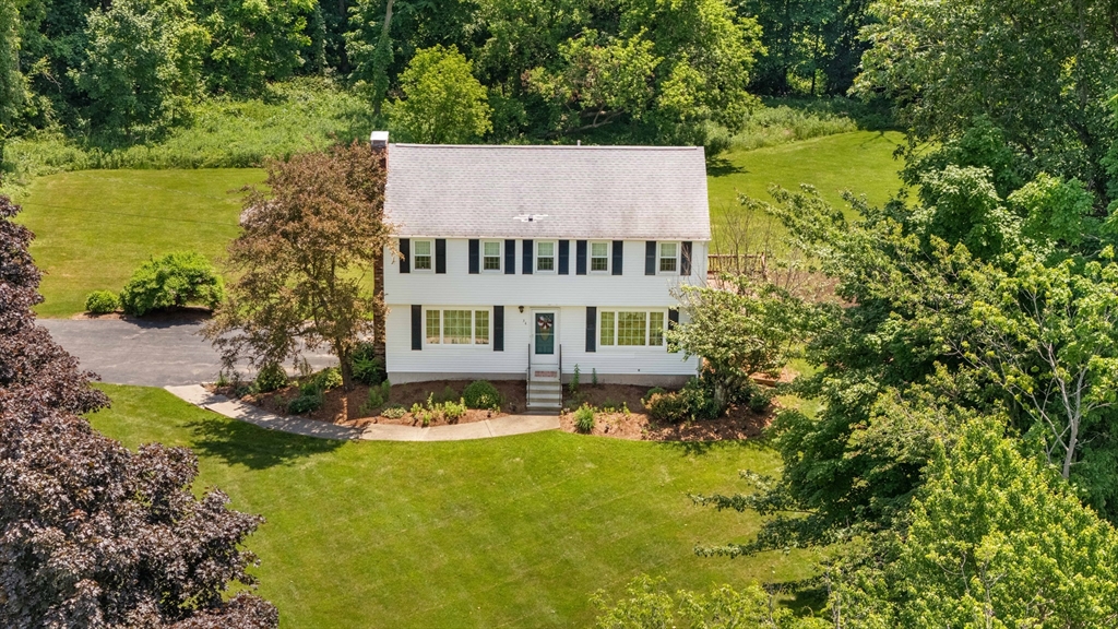 a view of a house with a yard and sitting area