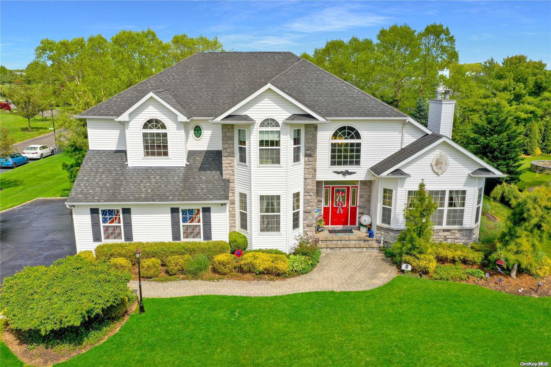 a view of a house with a yard and potted plants