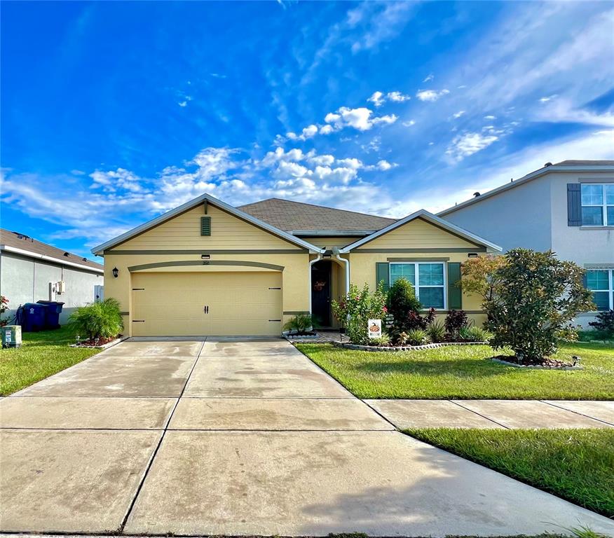 a front view of a house with yard and green space